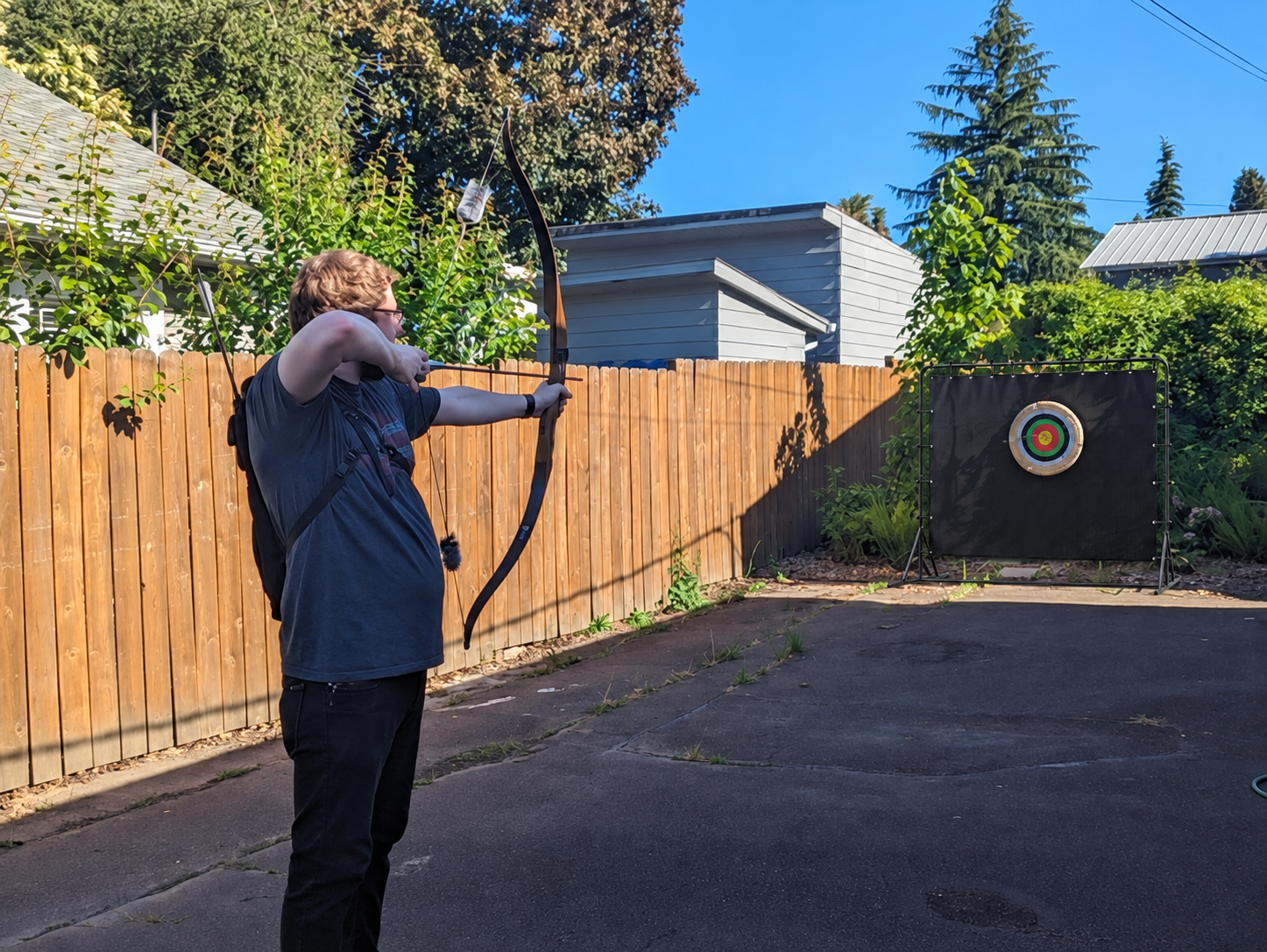 Archer practicing with the Ironcrest backstop behind the target